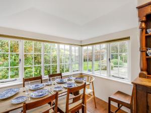 a dining room with a table and chairs and windows at 4 Bed in Near and Far Sawrey LLH02 in Near Sawrey