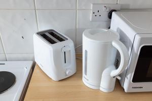 a kitchen counter with a toaster and a coffee maker at Large Studio on Finchley Road 10 in London