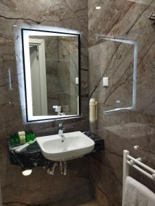 a bathroom with a sink and a mirror at Agora' Boutique Self-Check In in Sofia