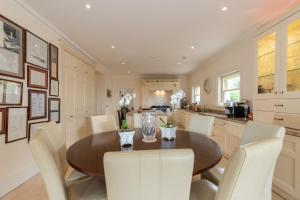 a kitchen and dining room with a wooden table and chairs at Dromard in Kenmare