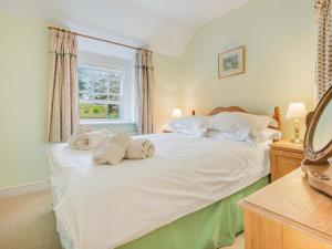 a bedroom with a large white bed with towels on it at 3 Bed in Lazonby SZ198 in Kirkoswald