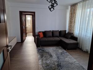 a living room with a couch and a table at Downtown Apartment in Râmnicu Vâlcea