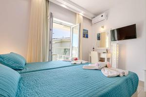 Voodi või voodid majutusasutuse Palotel Design Gouvia toas