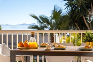 a wooden table with food on a balcony at Chalet Mirador 3A in Alcanada