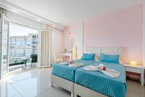 Voodi või voodid majutusasutuse Palotel Design Gouvia toas