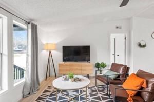 a living room with a couch and a tv at Starlight Horizon Cabin C - Pet-Friendly Texas Hill Country Cabin Near Canyon Lake - Pool, Stargazing & Group Getaways Sleeps 8 in Canyon Lake