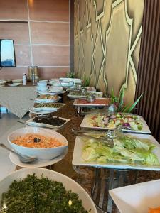 a buffet with many plates of food on a table at Villa Park in Al Khobar