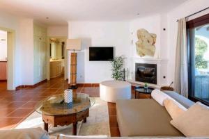 a living room with a couch and a fireplace at Authentic 4BR Pool & Sauna Villa, Sant Agusti in San Antonio Bay