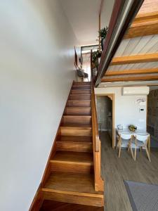 a staircase in a house with a table at Ático Almuiña. in Marín