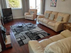 a living room with two couches and a television at Island view in Spittal