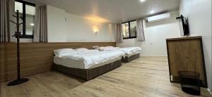 Postel nebo postele na pokoji v ubytování Fulong City B&B