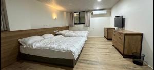 Postel nebo postele na pokoji v ubytování Fulong City B&B
