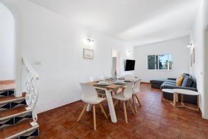 a dining room and living room with a table and chairs at Los Corcos Rural Farm With Private Pool in Playa de San Juan