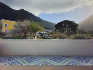 a balcony with a view of a mountain at Case vacanza La Palmas nel centro di Malfa in Malfa