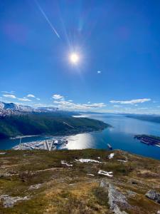 a view of a body of water with the sun in the sky at Quality Hotel Grand Royal in Narvik