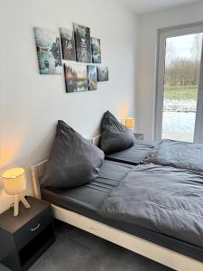 um quarto com 2 camas com almofadas e uma janela em Meine gemütliche Auszeit em Wolfsburg