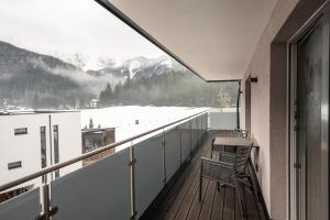 a balcony with a view of a snowy mountain at Apartment Gosauschmied in Gosau