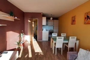 a kitchen and dining room with a table and chairs at Quiet Mountain Home, Free Parking & View in Sofia