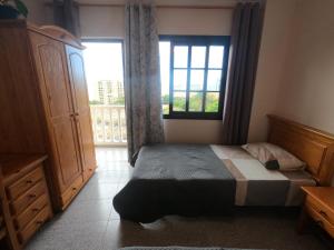 a bedroom with a bed and a large window at Twin Room at Villa Lila in Puerto de la Cruz