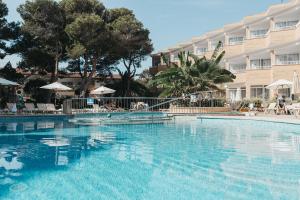 a large swimming pool in front of a hotel at Hotel Xaloc Playa in Punta Prima