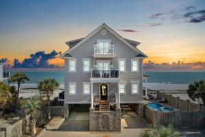 a house on the beach with the ocean in the background at Sea Something Beautiful in Myrtle Beach