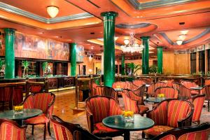 a restaurant with tables and chairs and a bar at Milan Marriott Hotel in Milan