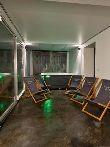 a group of chairs sitting in a room at Apartamenty Satoła Ciągłówka in Zakopane