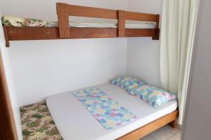 a bunk bed with two pillows on the bottom bunk at Tarot Residence in Florianópolis