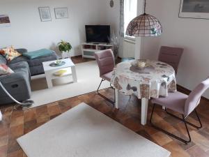 a living room with a table and chairs and a couch at Ferienwohnung Gieseking in Porta Westfalica