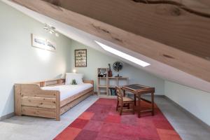 a attic bedroom with a bed and a table at Chalet ZigueZague - Calme - Proche Thermes in Saint-Gervais-les-Bains