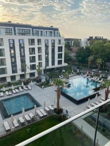 a hotel with a pool and chairs and a building at Apartment A - Lifestyle Holiday in St. St. Constantine and Helena