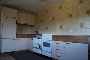 a kitchen with white appliances and a white refrigerator at Ferienhaus Lila in Hittisau