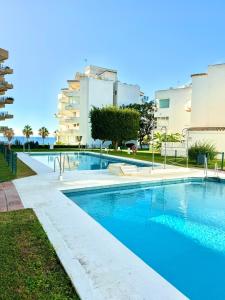 a large swimming pool in front of a building at SEA VIEW & BEACH ACCESS - Center - Parking in Marbella