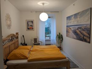 a bedroom with a bed and a pendant light at zum runden Turm in Andernach
