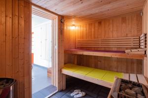 a sauna with a bench in a wooden cabin at Villa Castalie - Maison de maître, grande piscine et jacuzzi, classée 5 étoiles in Montrichard +43 photos
