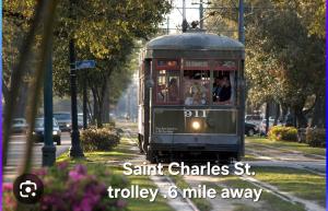 a trolley car traveling down a city street at Central City Charm in New Orleans