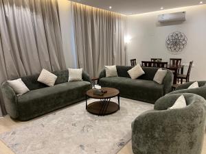 a living room with two couches and a table at الماجدية 53 ( A3) in Riyadh