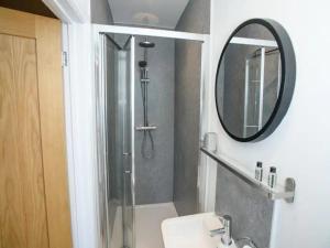 a bathroom with a shower and a sink and a mirror at Pass the Keys Garden Room in City Centre in Lincoln