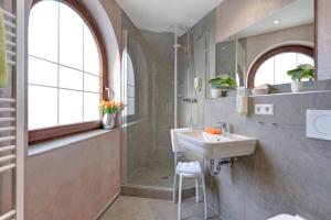 a bathroom with a sink and a shower at Hotel Restaurant Falken in Baiersbronn +51 photos