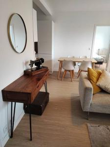 uma sala de estar com um espelho, uma mesa e um sofá em Sweet home em Lille