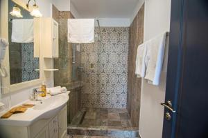 La salle de bains est pourvue d'un lavabo et d'une douche. dans l'établissement Alessio Hotel Residence, à Costinesti