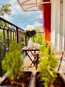 a balcony with a table with two vases on it at Apart-Hotels-Sofia, AHS in Sofia