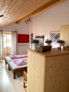 a bedroom with a bed and a table in a room at Appartement Aldea in Bad Aibling