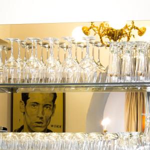 a group of glasses on a shelf in front of a mirror at Schlossberghotel in Graz