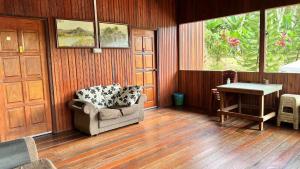 a living room with a chair and a table at Country house Pulai Holiday Village in Gua Musang