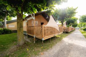 a house with a porch with a teepee on it at Glamping Italian Riviera in Isolabona