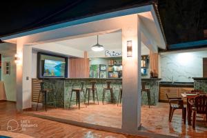 a bar in a restaurant with bar stools at Ria Aparta Hotel in San Felipe de Puerto Plata