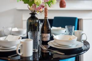 een tafel met een fles wijn en twee bekers bij Modern Living in the Heart of Covent Garden! 6BC in Londen