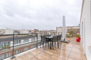 a balcony with a table and chairs on a building at Resident- Beautiful 6P apartment in Montrouge