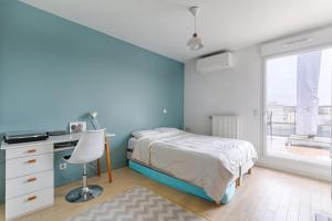 a bedroom with a bed and a desk and a window at Resident- Beautiful 6P apartment in Montrouge